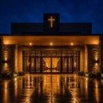 The front entrance of Christ Peace Church lit up at night